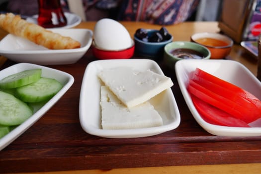 A beautiful assortment of breakfast items showcases fresh vegetables and cheese.