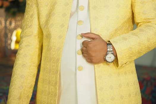 Person in a chic yellow outfit stands confidently with elegance.