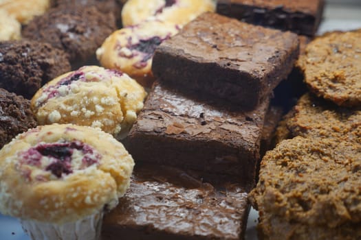 A variety of baked treats including brownies and muffins ready for sale.