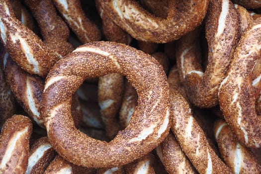 Vendors showcase golden-brown simit sprinkled with sesame seeds.