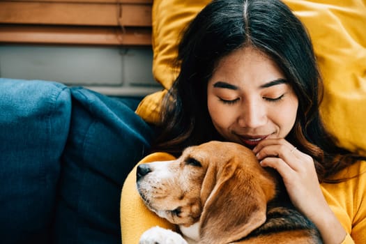 A portrait of happiness, a woman and her Beagle dog sleep peacefully on the sofa in the living room, embodying the concept of best friends forever and the joy of togetherness. Pet love