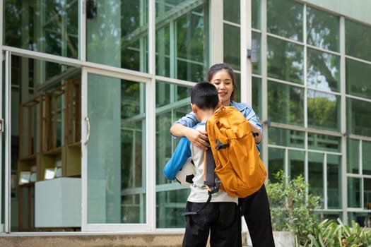 Emphasizing the importance of family support, a mother assists her son before school, showcasing a loving parental role in education.