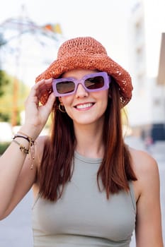 portrait of a happy young woman with hat and sunglasses smiling looking at camera, concept of youth