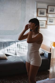 A young woman begins her day with a relaxing morning routine, surrounded by warm light in a cozy setting