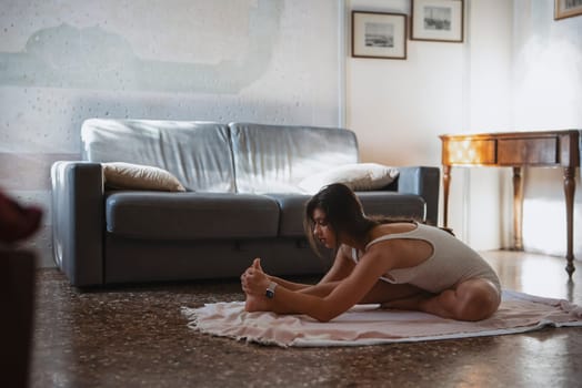 A woman stretches in her serene living room, highlighting wellness and mindfulness, showcasing inner peace