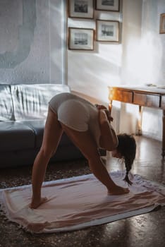 A woman gracefully practicing yoga poses in a serene indoor setting, with soft natural light gently filtering through