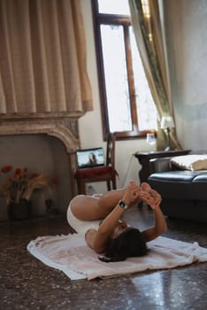 A tranquil indoor space with someone practicing yoga, improving flexibility and achieving deep relaxation
