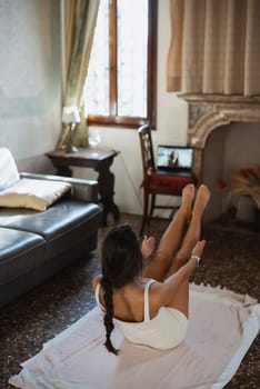 A woman practices yoga in a beautifully bright living room, fully embracing wellness, health, and mindfulness