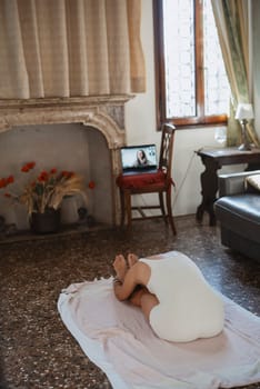 A serene and peaceful indoor scene featuring a person comfortably relaxed at home while using a laptop