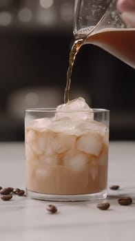 Refreshing cold brew coffee being poured over ice in a glass, highlighting a perfect summer drink.