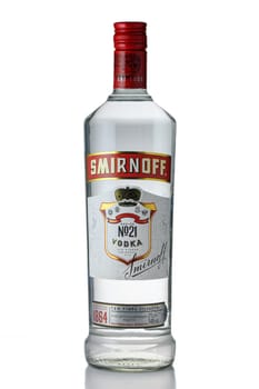 Gaziveren Cyprus -04.04.2025 Crafted for sophistication, a transparent Smirnoff vodka bottle sits elegantly against a simple backdrop. The bright red cap adds a vibrant touch, perfect for gatherings or special occasions.
