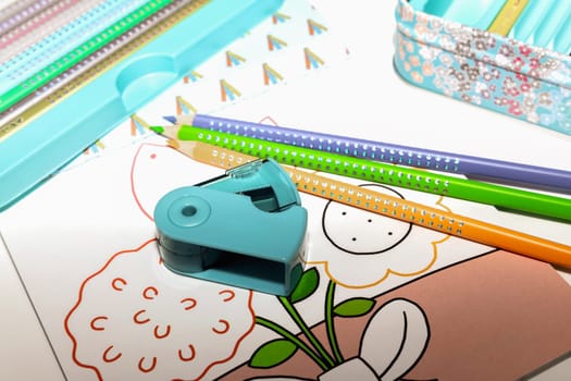 Colored pencils for drawing various colors and coloring book for children. High quality photo