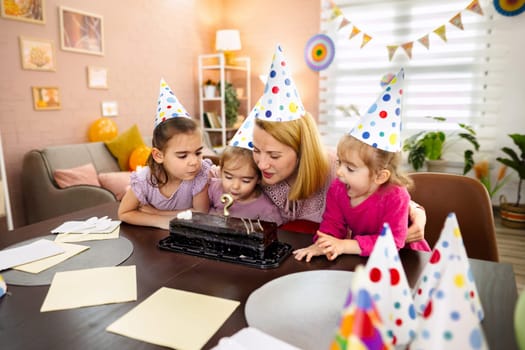 Children gather around to celebrate a birthday with cake and laughter.