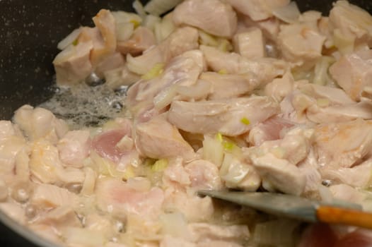Tender pieces of chicken simmer in a hot skillet, mingling with softly sauteed onions. The warmth of the kitchen fills the air with mouthwatering aromas as the sun begins to set.