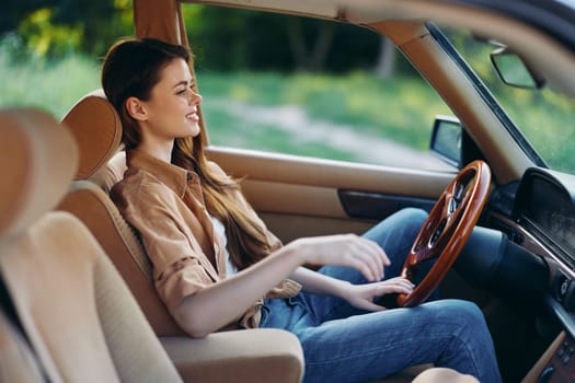 Joyful young woman enjoying a drive in a vintage car, capturing the essence of freedom and adventure in a natural green setting, ideal for travel and lifestyle concepts.