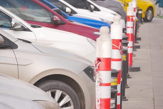 Multiple vehicles are well-organized in a parking area during daytime.