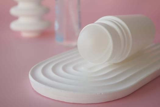 Deodorants on a textured surface with soft colors,