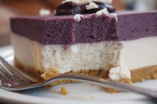 A delicious layered dessert features creamy cheese and berry flavors.