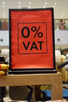 Bright red sign indicates zero value-added tax on merchandise inside the store.