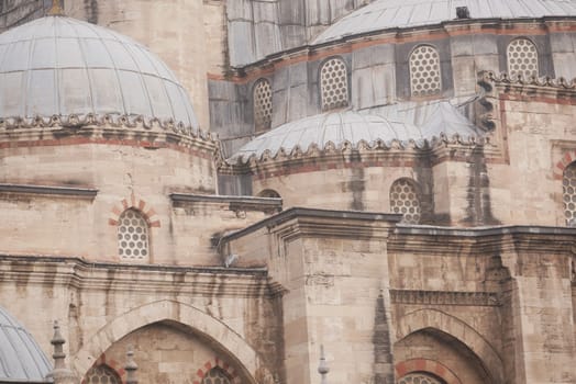 Intricate designs and domes of a historic mosque showcase craftsmanship.