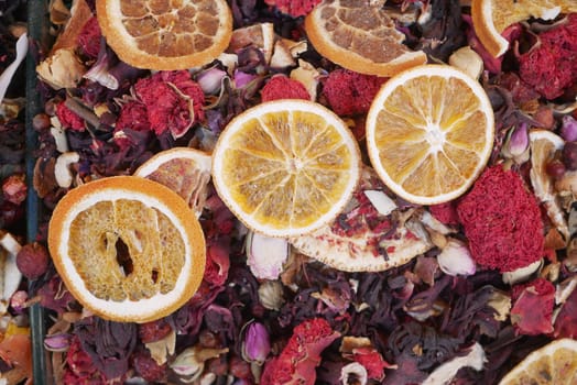 A vibrant assortment of dried fruits and flowers on a market stall.