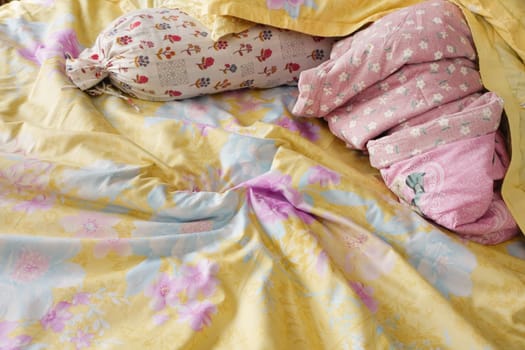 messy bed in a bright space.