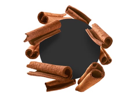 Cinnamon sticks on a white background with a black circle in the center. The black circle is the place for the text or logo