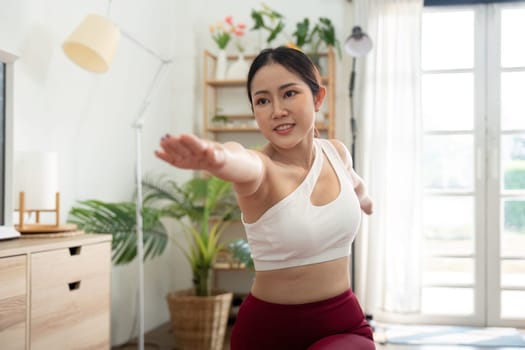 A woman energetically practices yoga, embodying empowerment and movement, highlighting her journey towards health and wellness.