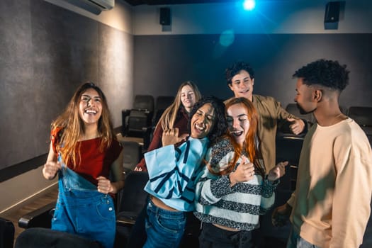 Group of friends enjoying a disco dance event at the cinema, laughing and having fun together