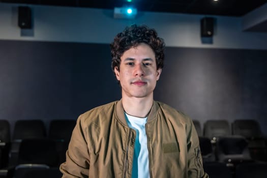 Young man enjoying a movie showing in an empty cinema, experiencing a unique and private cinematic moment