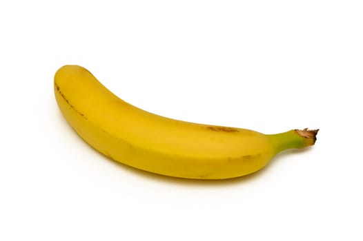 A single yellow banana rests elegantly on a white surface, its smooth skin glistening. The gentle curve and rich hue highlight its freshness, inviting a closer look.