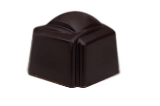 Silky dark chocolate truffle sits elegantly on display, its glossy exterior catching the light. This handcrafted delicacy promises a burst of rich flavor, enticing chocolate lovers everywhere.