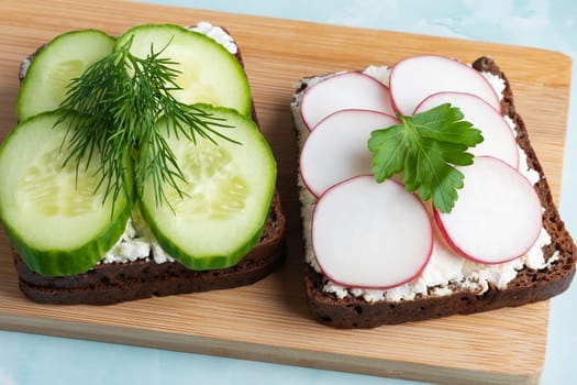 Freshly prepared open-faced sandwiches with cucumbers and radishes.