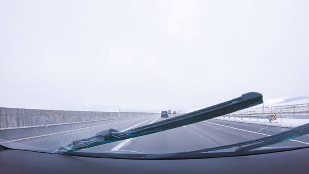 Denver, Colorado, USA-January 26, 2024-The open highway invites a peaceful drive, with snow-clad pines lining I-25 as the journey continues from Denver towards Colorado Springs on a snowy day.