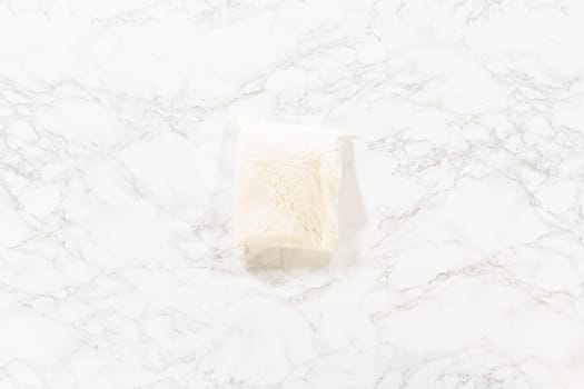 Flat lay. In a cozy kitchen, ingredients are meticulously measured in glass mixing bowls on the kitchen counter, all set to create a delightful homemade pumpkin bundt cake from cake mix.