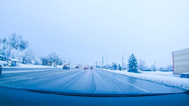 Colorado Springs, Colorado, USA-January 26, 2024-The open local roads invites a peaceful drive, with snow on the road as the journey continues from Denver towards Colorado Springs on a snowy day.