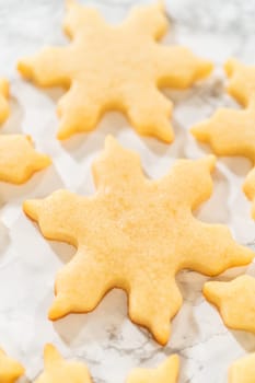 Crisp golden snowflake cookies captured up-close, emphasizing their perfect festive design and smooth texture.