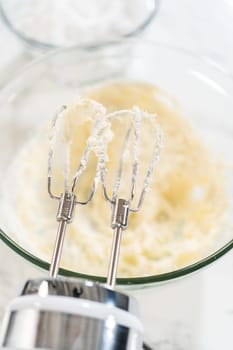 Preparing cream cheese frosting to ice the delicious pumpkin bundt cake.