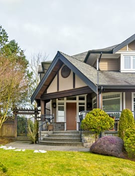 A perfect neighborhood. Nicely landscaped front yard of luxury residential house with paved pathway to the entrance. Luxury residential house for sale