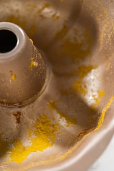 A close-up view of a dirty bundt cake pan after baking the pumpkin bundt cake.