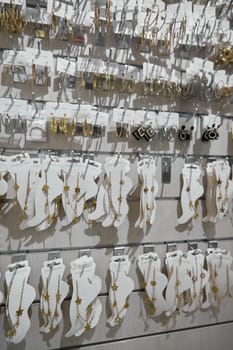 A neatly arranged showcase featuring gold and silver rings alongside delicate bracelets, with intricate designs and vibrant charm for shoppers.