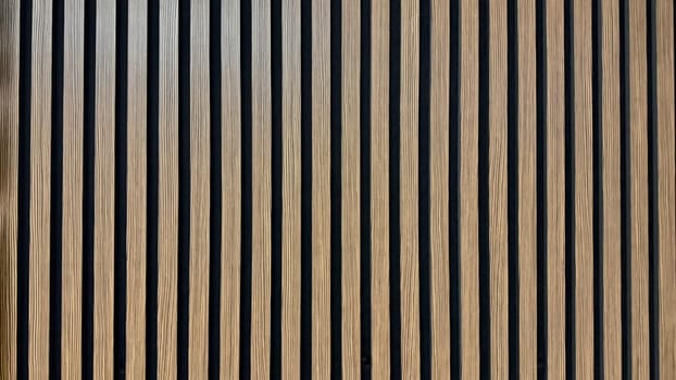Vertical Wooden Slats Creating a Patterned Architectural Design on Indoor Walls. Vertical wooden slats form a visually appealing architectural wall design, enhancing interior aesthetics and texture. Suitable for modern and contemporary settings, it offers a sleek appeal with natural tones.