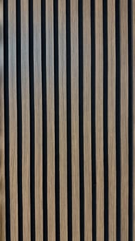 Modern Wooden Panel with Vertical Striped Design for Contemporary Interiors. A close-up view of a wooden panel featuring vertical striped patterns in a modern design, perfect for architectural and interior design concepts emphasizing simplicity, texture, and elegance. Can be used like background.