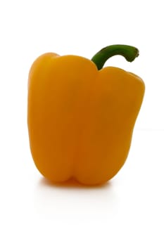 A vibrant yellow bell pepper sits elegantly on a smooth white surface, highlighting its glossy texture and inviting shape. This striking vegetable adds a pop of color to any culinary creation.