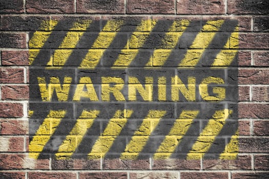 A Warning danger sign with yellow and black stripes on brick wall background