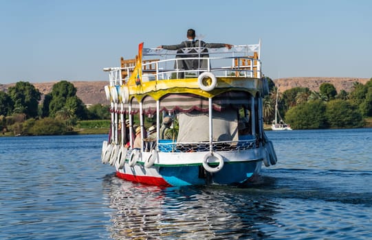 A scenic boat cruise on the Nile River near Aswan, Egypt, under a clear blue sky. and heading across the river for bird watching