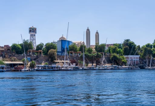 Aswan Archangel Michael Coptic orthodox cathedral on the shore with boats docked on the River Nile