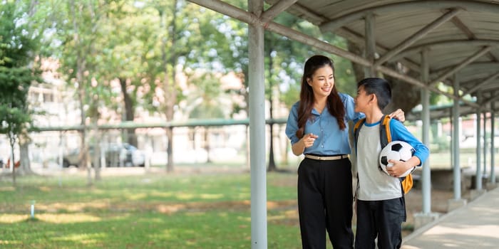 A parent and child enjoy a walk in a school environment, discussing their day, and experiencing the beauty of learning together.