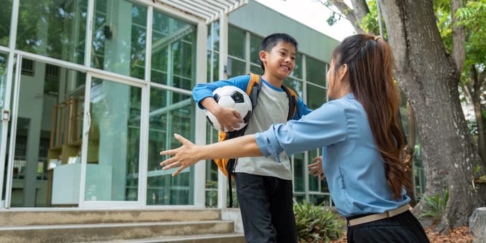 A heartwarming embrace between a mother and son right after school, celebrating their bond and the joy of soccer.