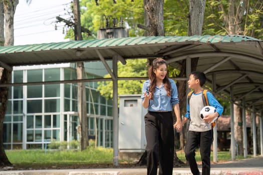 The duo shares a joyful exchange while navigating their way home together, fostering a bond over academics and sports like soccer.
